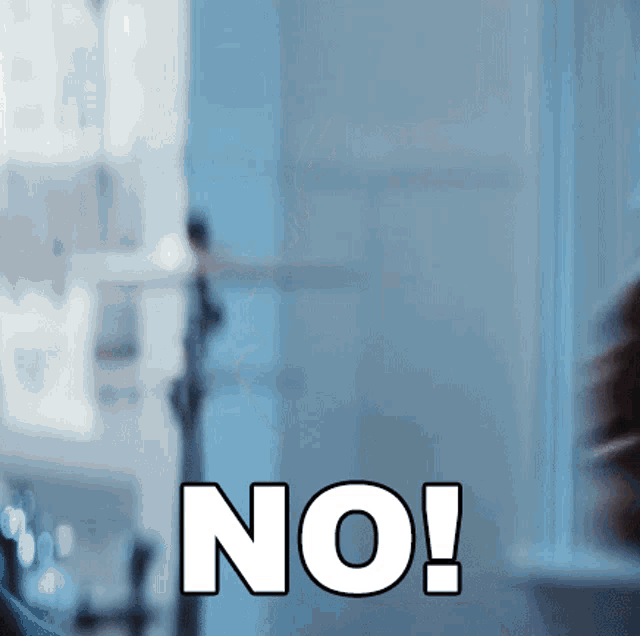 a person is standing in front of a window with the word no on it
