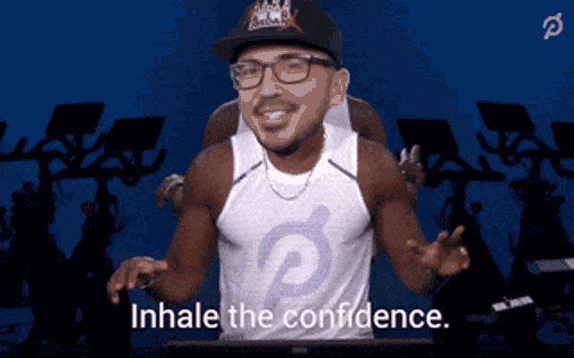 a man wearing a hat and glasses says " inhale the confidence "