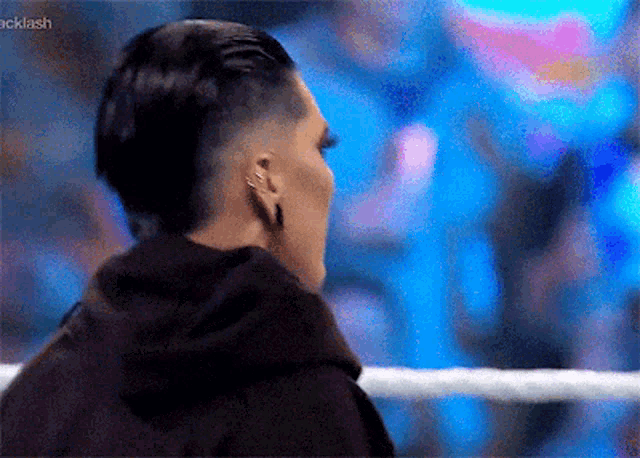 a woman with a mohawk is standing in a wrestling ring .