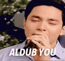 a man with his eyes closed is drinking from a bottle with the words aldub you on the bottom