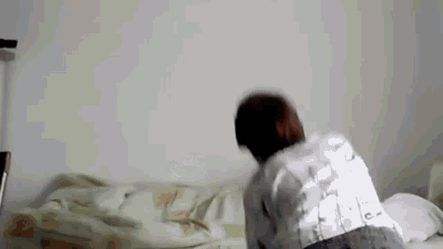 a person is laying on a bed with a white blanket and a cane .