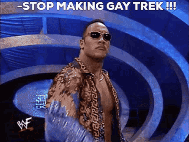 a man wearing sunglasses stands in front of a sign that says " stop making gay trek "