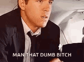 a man in a suit and tie is saying man that dumb bitch