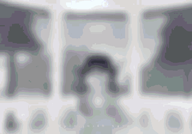 a blurred image of a person 's face with the letters a and b visible in the corner