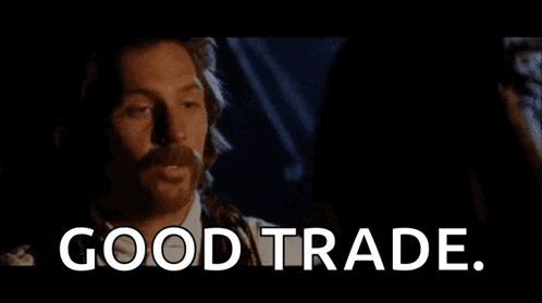 a man with a beard is talking to a woman and the words `` good trade '' are visible .