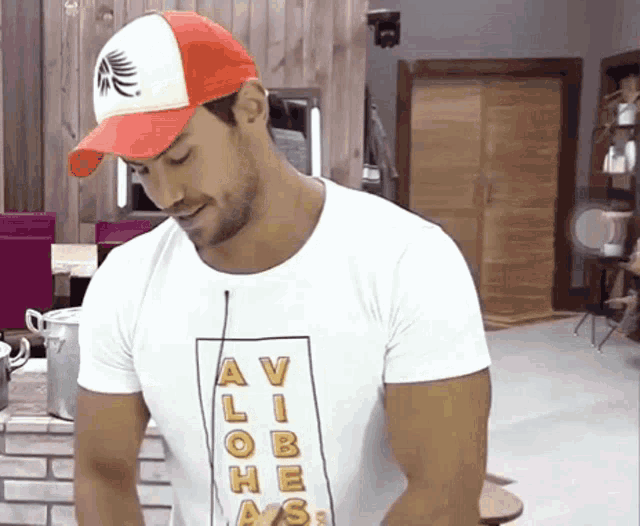 a man wearing a red hat and a white t-shirt that says av lobe ass