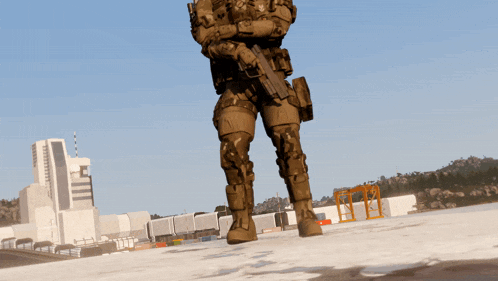 a soldier with a gun is standing in front of a building with the letter c on it