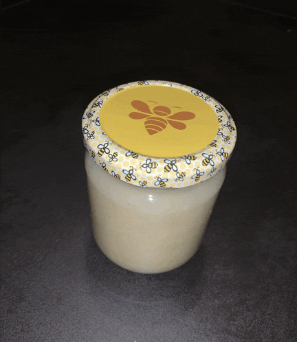 a jar with a bee on the lid