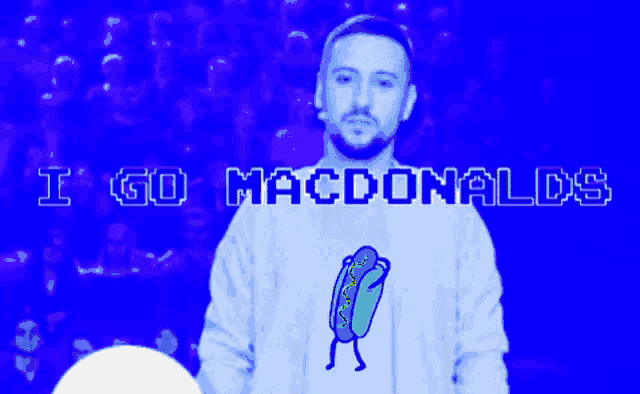 a man wearing a shirt that says ' i go macdonalds ' on it