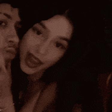 a man and a woman are posing for a picture and smiling .