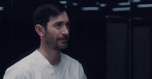 a man with a beard wearing a lab coat