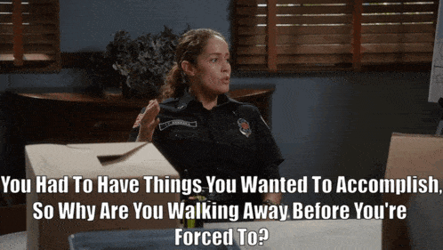 a woman in a police uniform is talking to a man in a suit