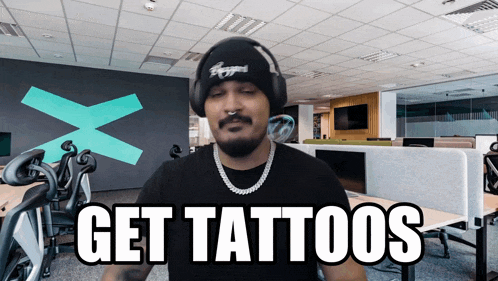 a man wearing headphones and a beanie says " get tattoos "