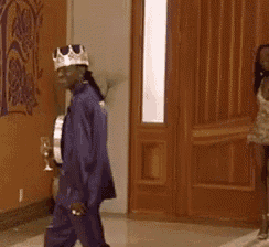 a man with a crown on his head is standing next to a woman