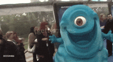 a blue monster with a big eye is standing in a crowd of people