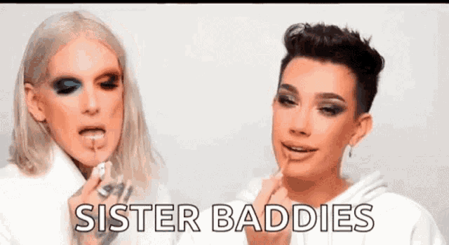 a man is applying makeup to another man 's face and the words `` sister baddies '' are written on the screen .