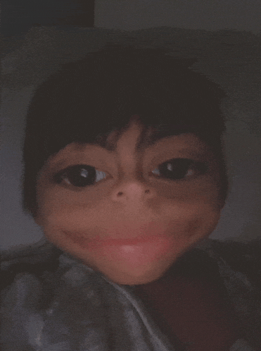 a close up of a child 's face with a big smile