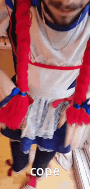 a man is dressed up as a little red riding hood with red hair