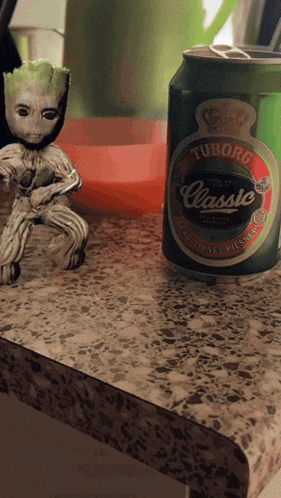 a can of tuborg classic beer sits on a counter
