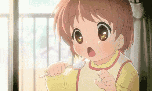 a little girl is holding a spoon in her hand and eating food .