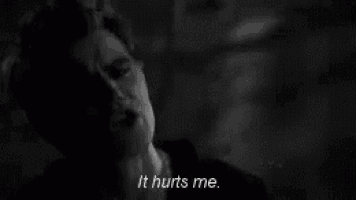 a black and white photo of a man says it hurts me .