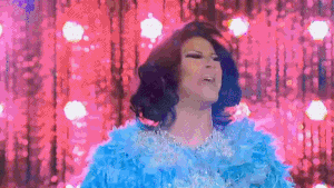 a drag queen is wearing a blue feather boa and a blue dress .