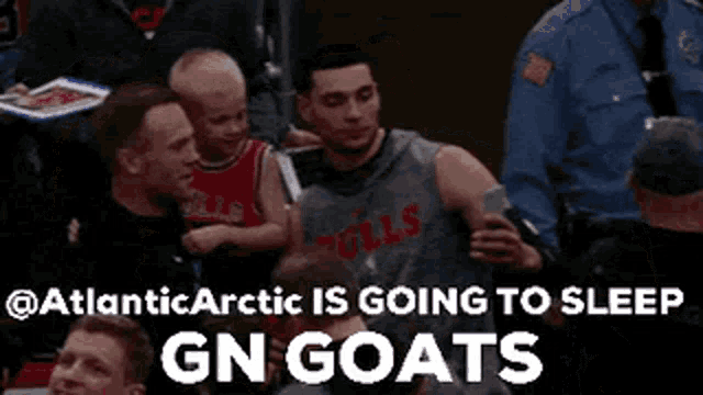 a man in a bulls jersey is holding a child in his arms