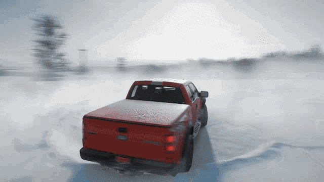 a red ford truck driving through the snow