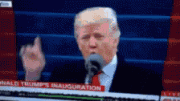 donald trump giving the middle finger in front of a microphone