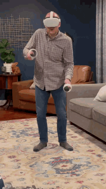 a man wearing a virtual reality headset is playing a game