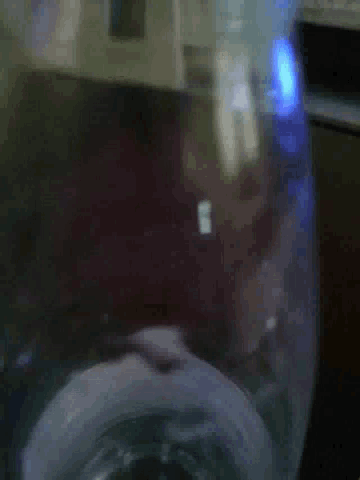 a blurred image of a washing machine with a blue light shining on it