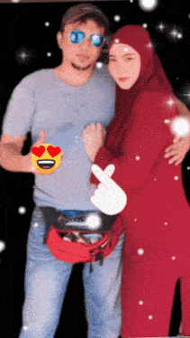 a man and woman are posing for a picture and the woman is wearing a red dress