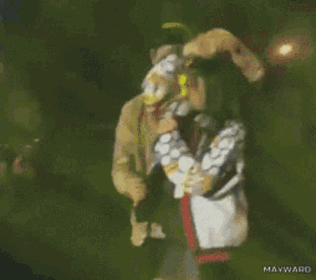 a man in a yellow jacket is holding a woman in a black and white polka dot jacket