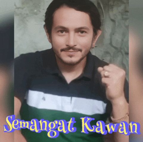 a man with a beard and mustache is wearing a green and black shirt with the words " semangat kawan " on the bottom
