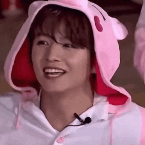 a close up of a person wearing a pink bunny hat .