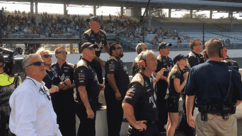 a group of people standing in front of a stadium with one man wearing a shirt that says n
