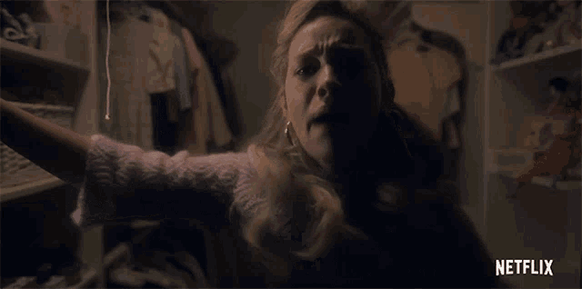a woman is screaming in a closet with netflix written on the bottom