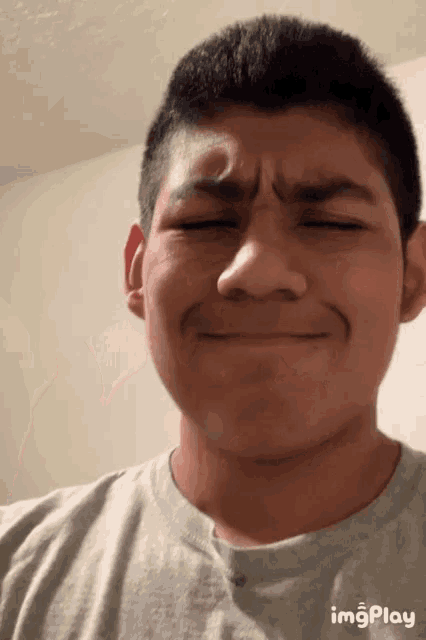 a close up of a man 's face with the words imgplay on the bottom right