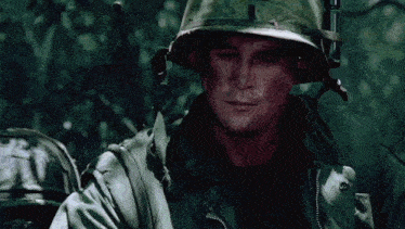 a soldier wearing a helmet and a jacket with the letter j on it