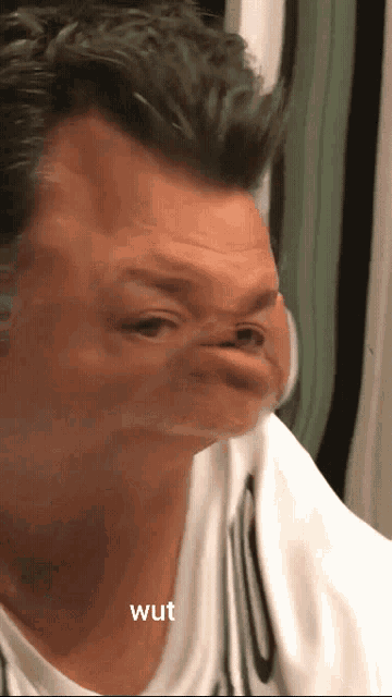 a close up of a man 's face with the word wut written below it