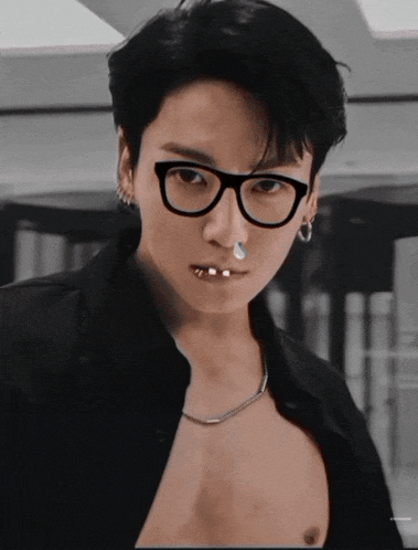 a man wearing glasses and a nose ring