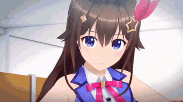 a girl with long brown hair and blue eyes is wearing a blue jacket and a bow tie .