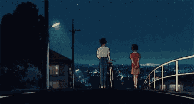 a man riding a bike stands next to a woman in a red shirt