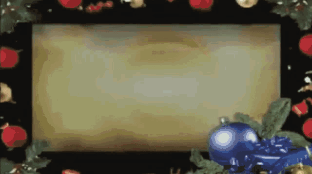 a picture frame with christmas decorations and a blue ball on it