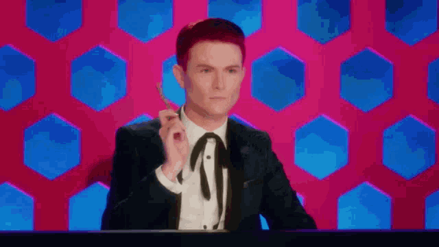 a man in a suit and tie is sitting at a table holding a key .
