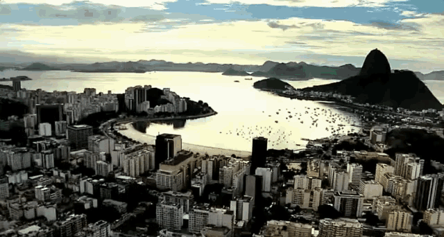 an aerial view of the city of rio de janeiro with mountains in the background