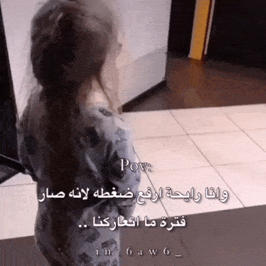 a little girl is standing in a hallway with a caption in arabic that says pov