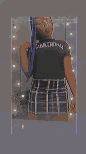 a girl with purple braids is taking a picture of herself