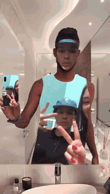 a man and a woman are taking a selfie in front of a bathroom mirror