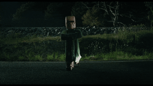 a car is driving down a road at night and a person is flying in the air